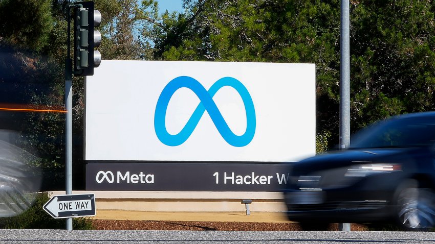 FILE – A car passes Facebook’s new Meta logo on a sign at the company headquarters on Oct. 28, 2021, in Menlo Park, Calif.