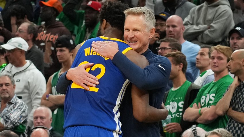 BOSTON, MA – JUNE 16: Andrew Wiggins #22 of the Golden State Warriors embraces Head Coach Steve Kerr of the Golden State Warriors during Game Six of the 2022 NBA Finals on June 16, 2022 at TD Garden in Boston, Massachusetts. NOTE TO USER: User expressly acknowledges and agrees that, by downloading and or using this photograph, user is consenting to the terms and conditions of Getty Images License Agreement. Mandatory Copyright Notice: Copyright 2022 NBAE (Photo by Jesse D. Garrabrant/NBAE via Getty Images)